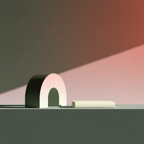 灰绿粉色的拱门书挡 / Two smooth arch-shaped bookends supporting one closed cream book on a low · Square